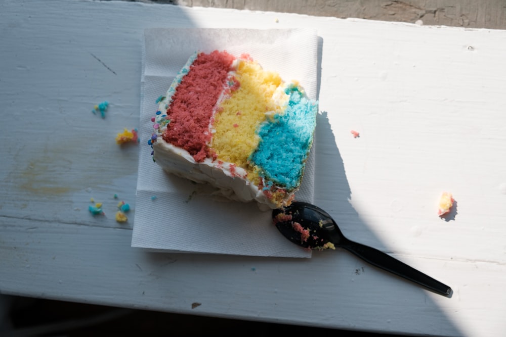 white yellow and pink cake on white paper