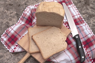 A bread slicer machine neatly slicing fresh loaves with precision.