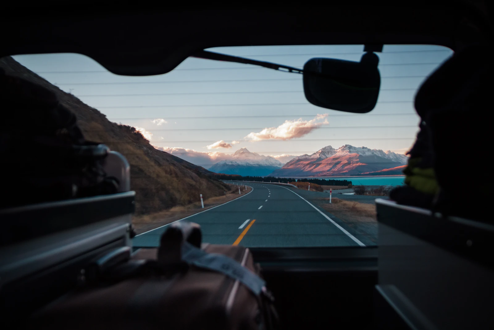 Two travelers on a scenic road trip in a car