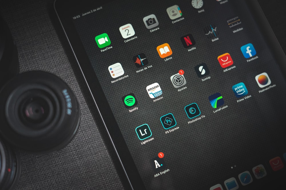 black ipad showing icons with icons