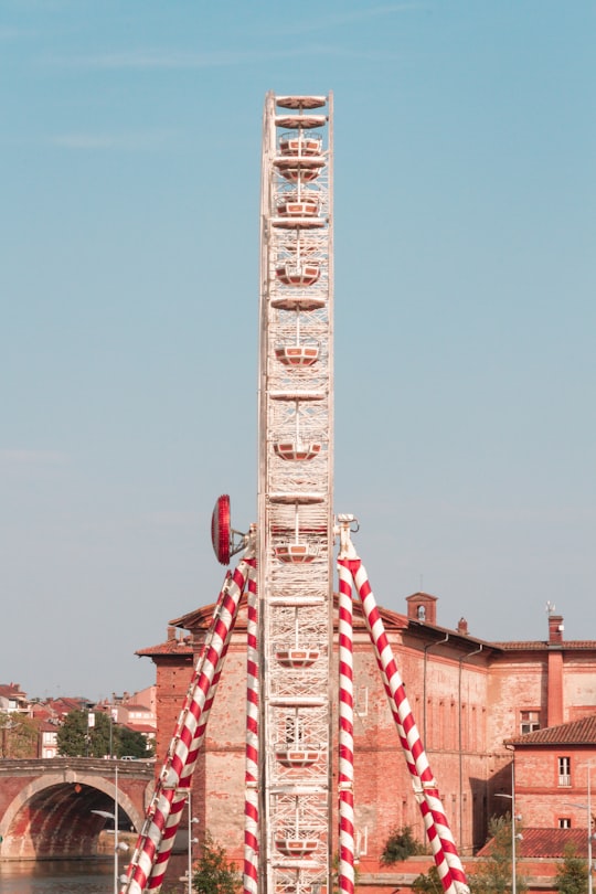 red and white tower under blue sky during daytime in Toulouse France