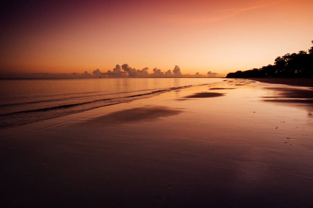 body of water during sunset