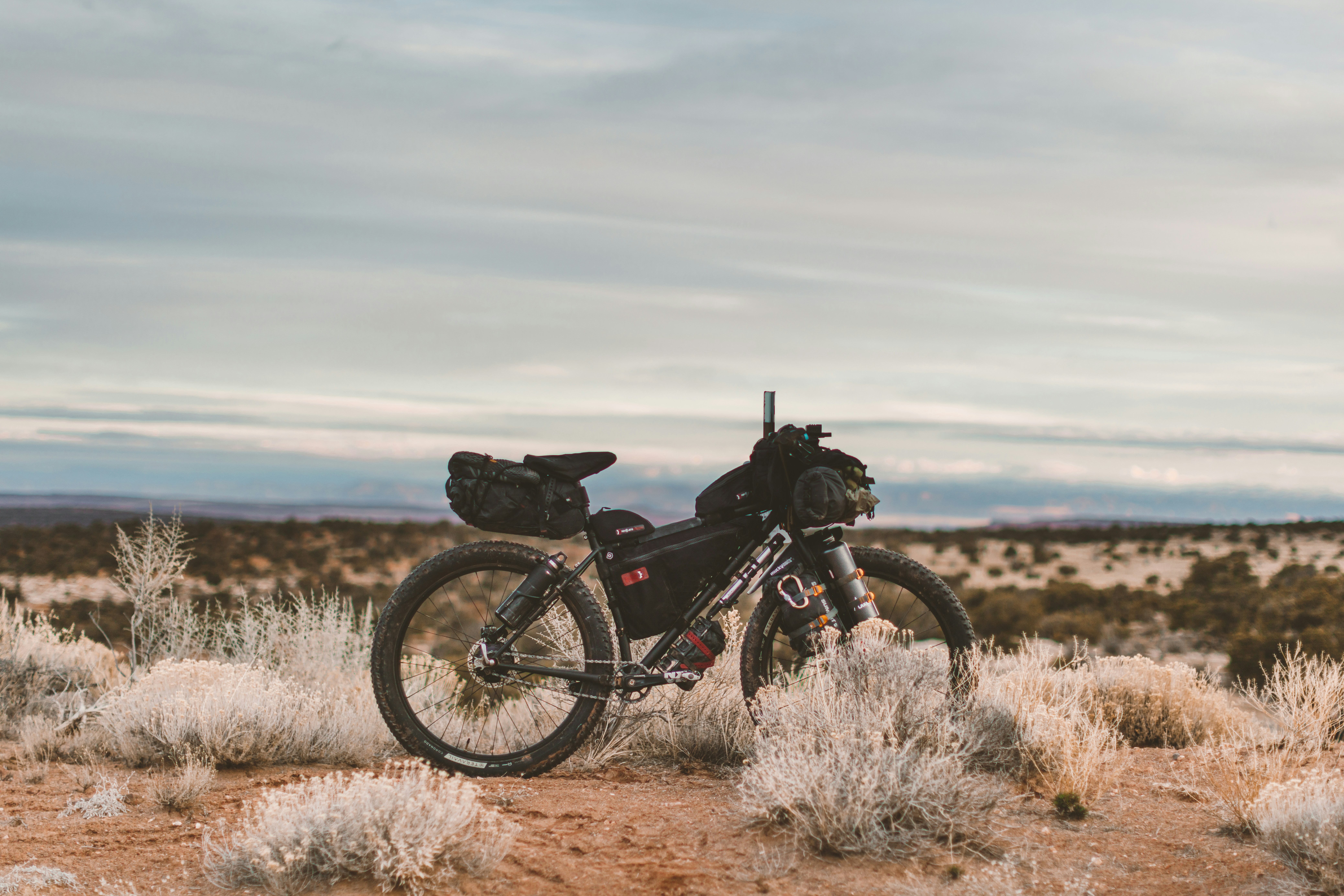 black motorcycle on brown field during daytime