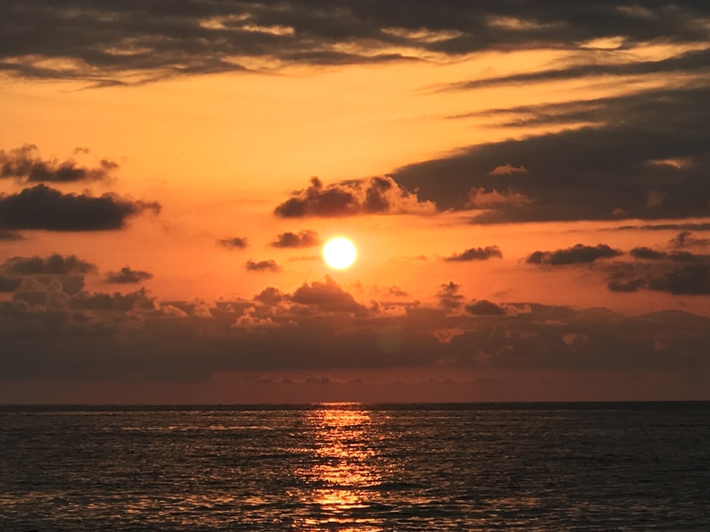 body of water during sunset