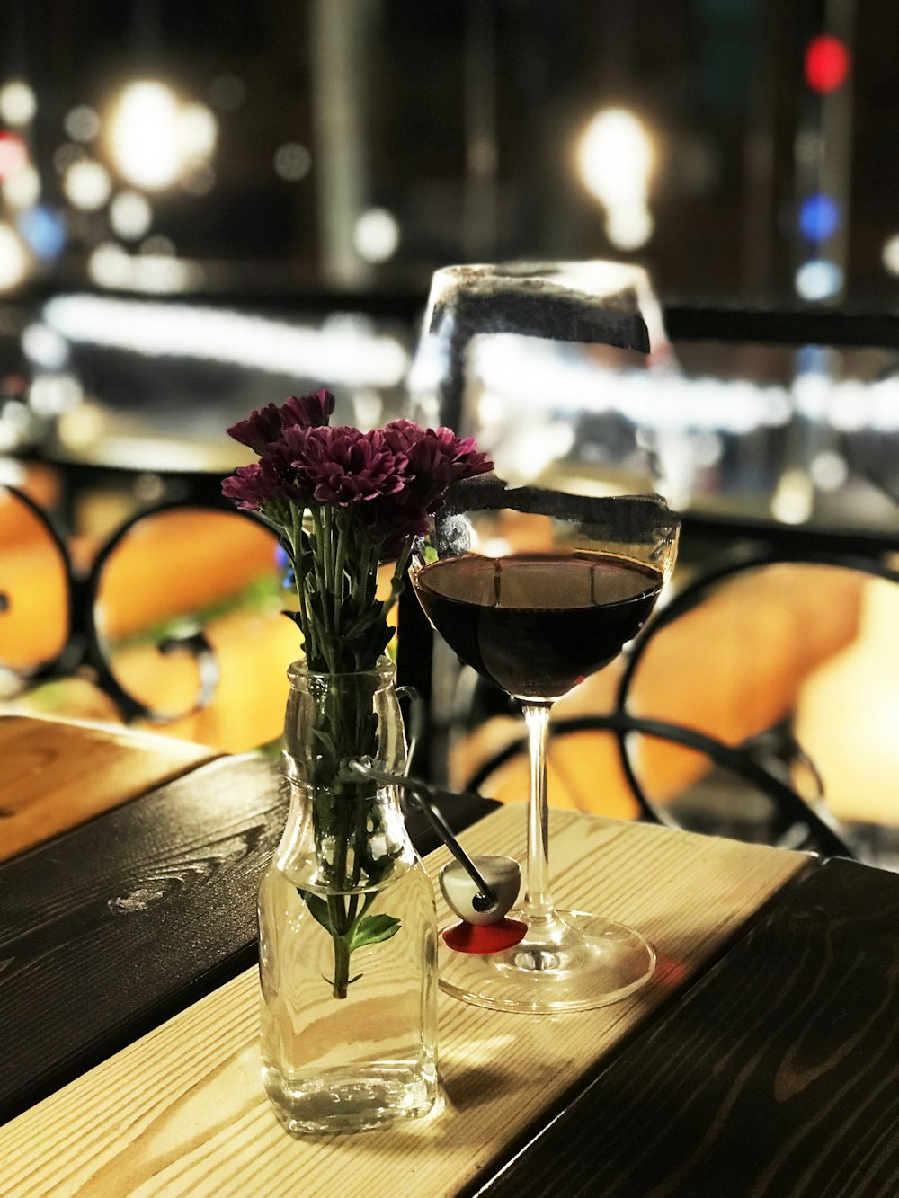 red flowers in clear glass vase on brown wooden table