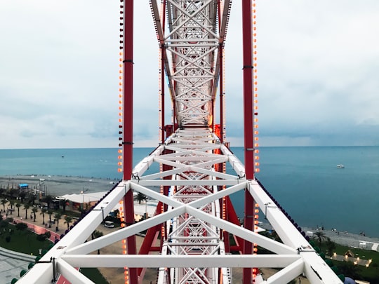 brown and white metal bridge over blue sea during daytime in Batumi Georgia