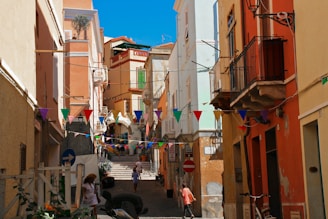 A lively group of travelers exploring the colorful streets of a Mediterranean town.