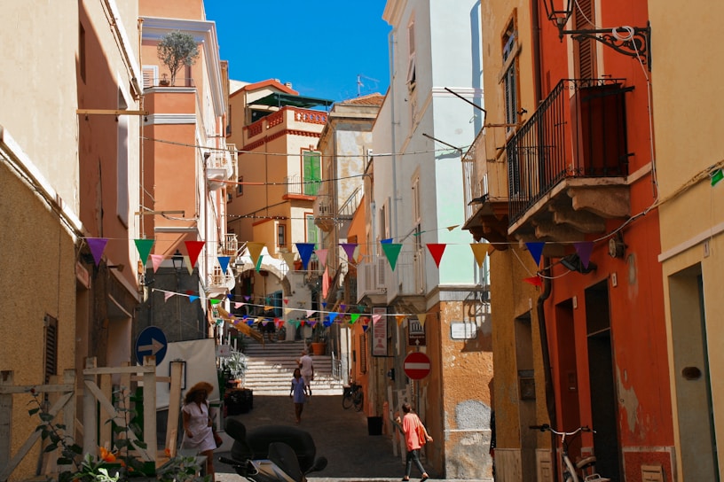 A lively group of travelers exploring the colorful streets of a Mediterranean town.