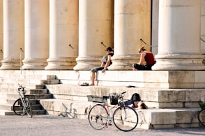 man in red shirt riding bicycle on gray concrete stairs during daytime