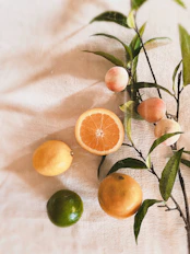orange fruits on white textile