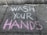 Brightly colored chalk writing on a concrete sidewalk with the words 'WASH YOUR HANDS' emphasized in white and pink.