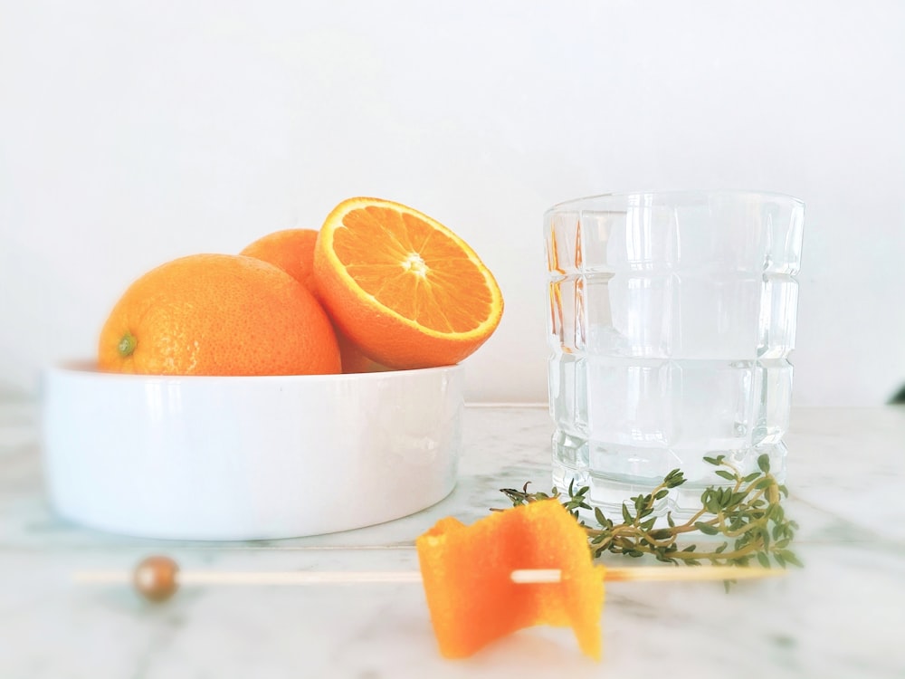 sliced orange fruit on clear glass cup