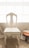 Elegant wooden chair beside a window with natural light highlighting its smooth finish.