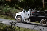 A truck driving on a scenic highway surrounded by nature.