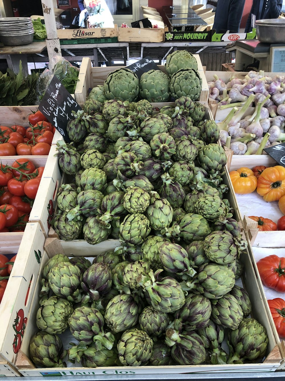 green and red fruit on brown wooden crate