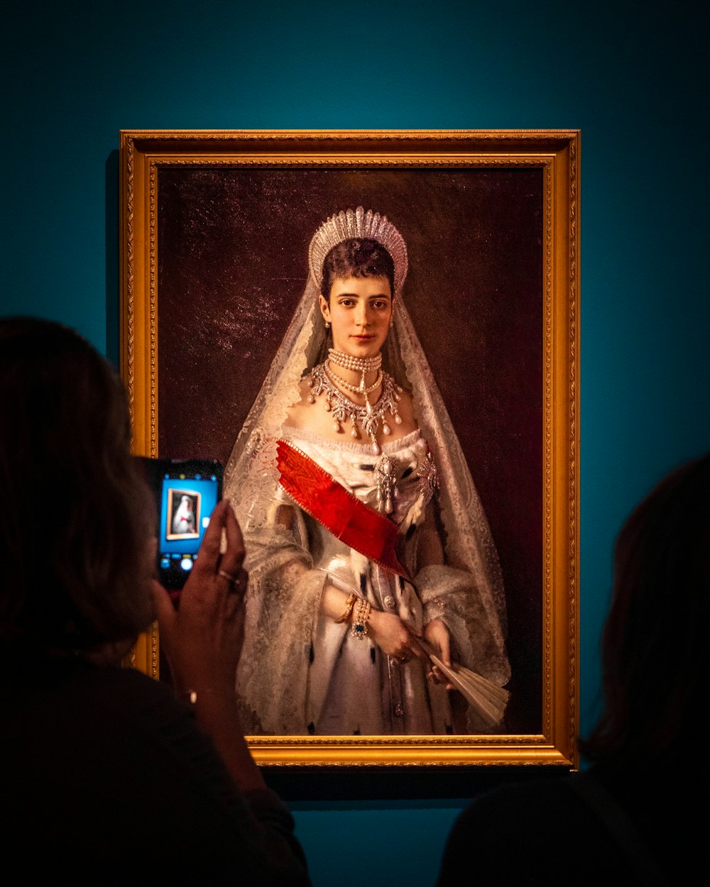 woman in white and red dress painting