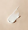 white cream smear on beige surface