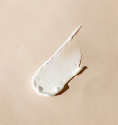 white cream smear on beige surface