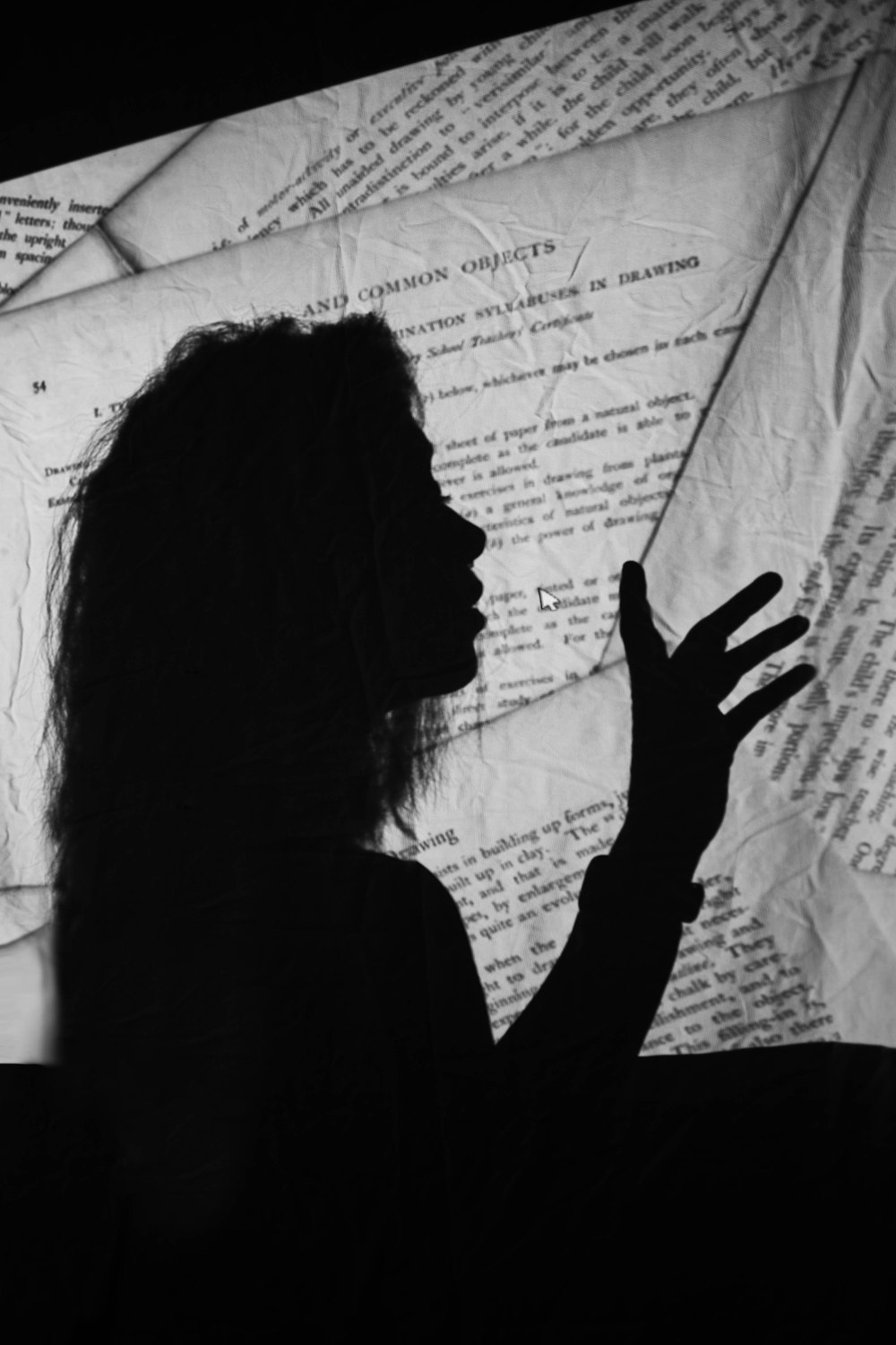 silhouette of woman covering face with hand