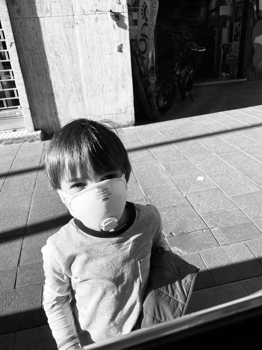 grayscale photo of boy in crew neck t-shirt and white headphones