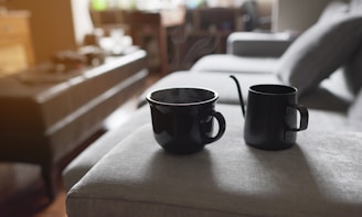 black ceramic mug on brown wooden table