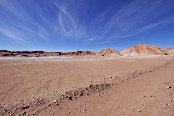 The bare sand and rock of the Atacama Desert under a cloudless sky near San Pedro