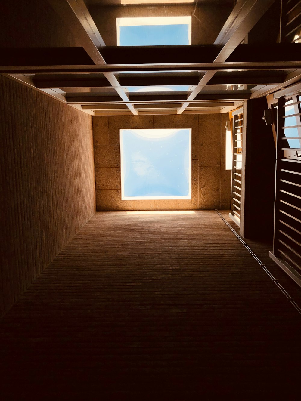 brown wooden hallway with white light