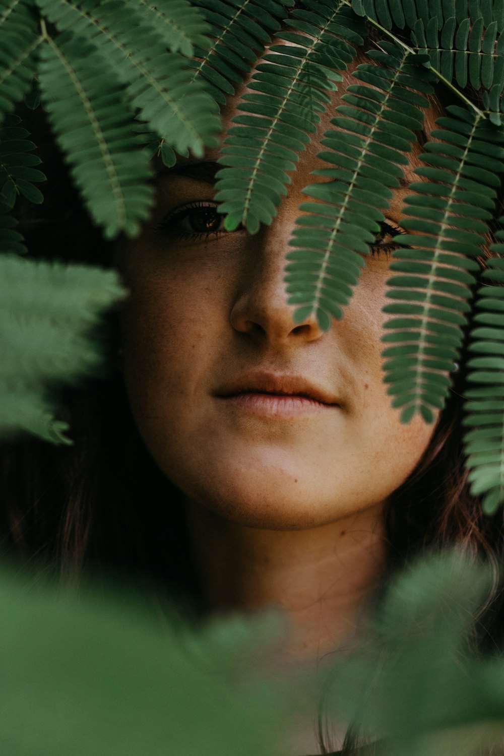 woman with green leaves on her head