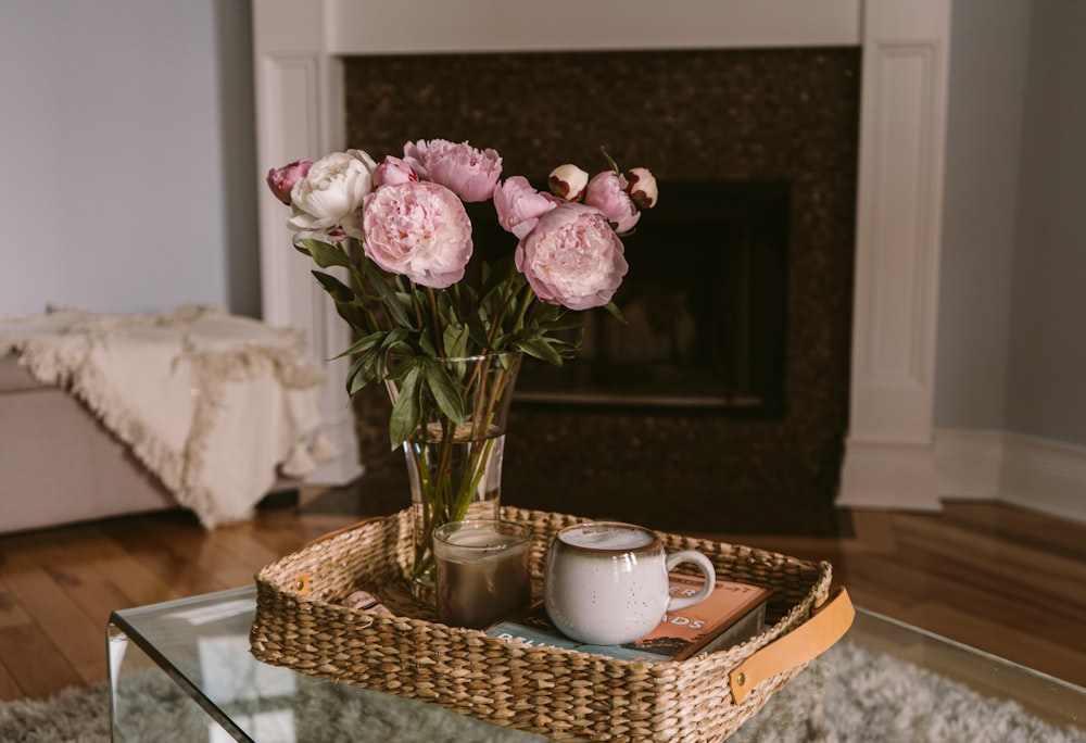 pink and white flowers on brown woven basket