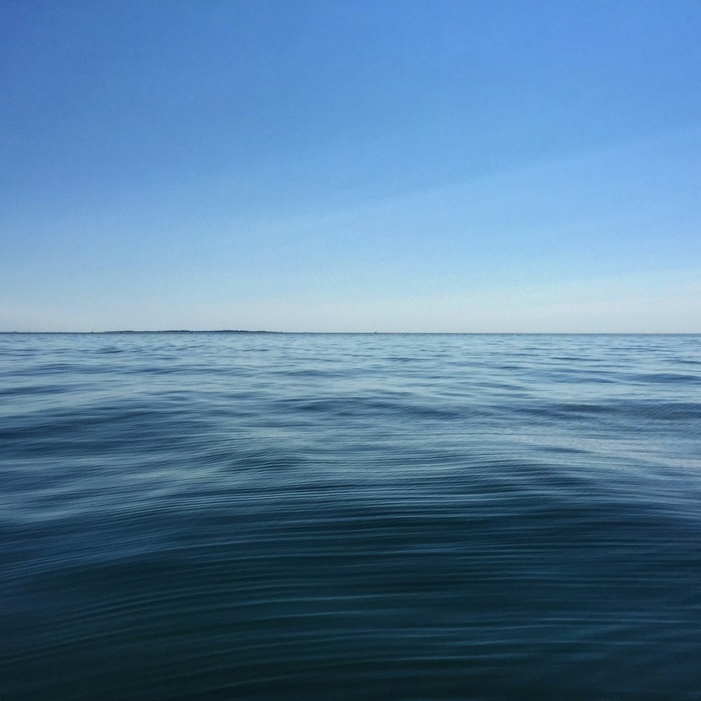 blue ocean water under blue sky during daytime