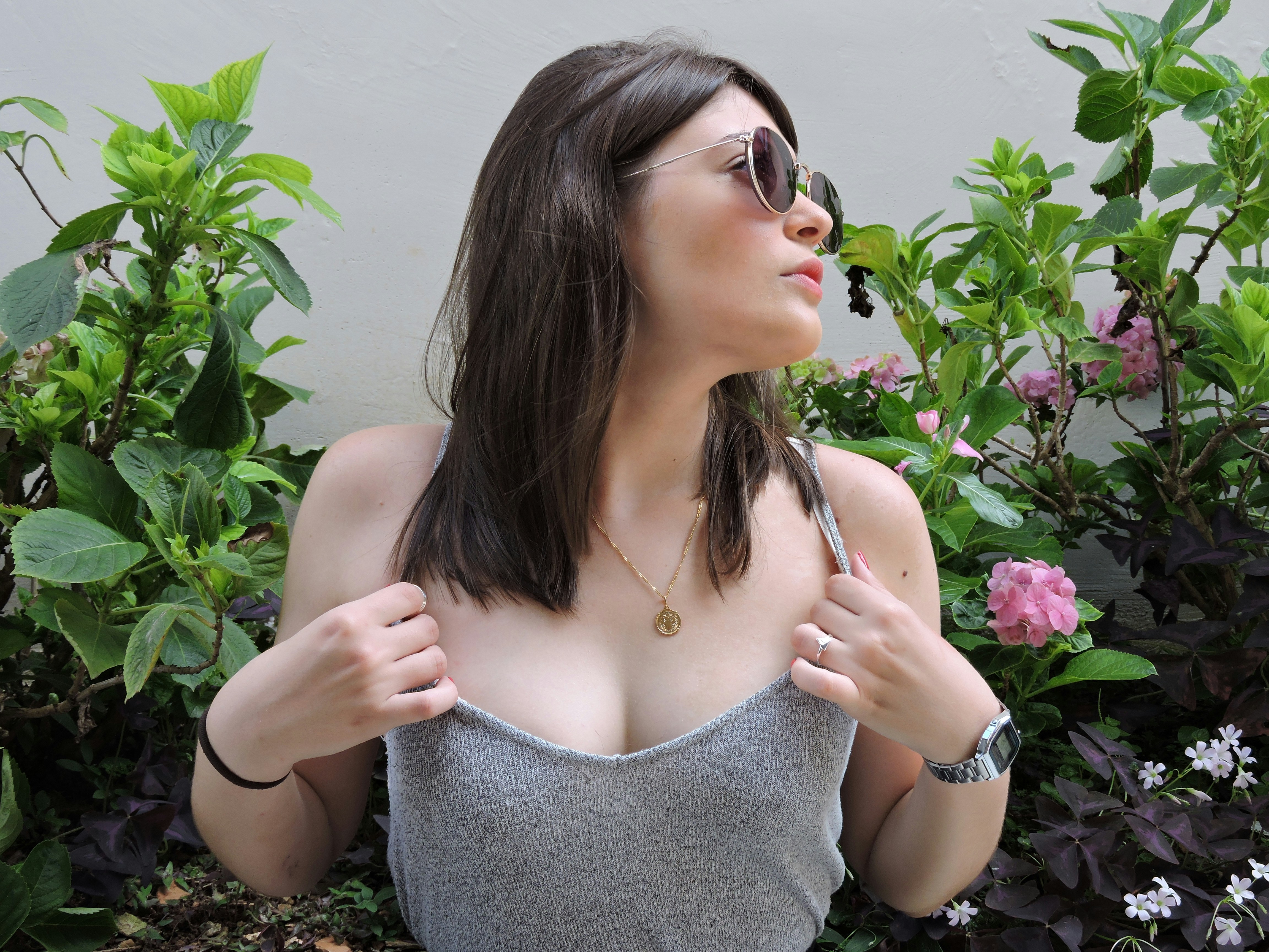 Young woman in sunglasses with plants