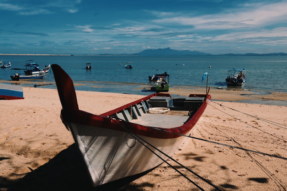 brown wooden boat on beach during daytime