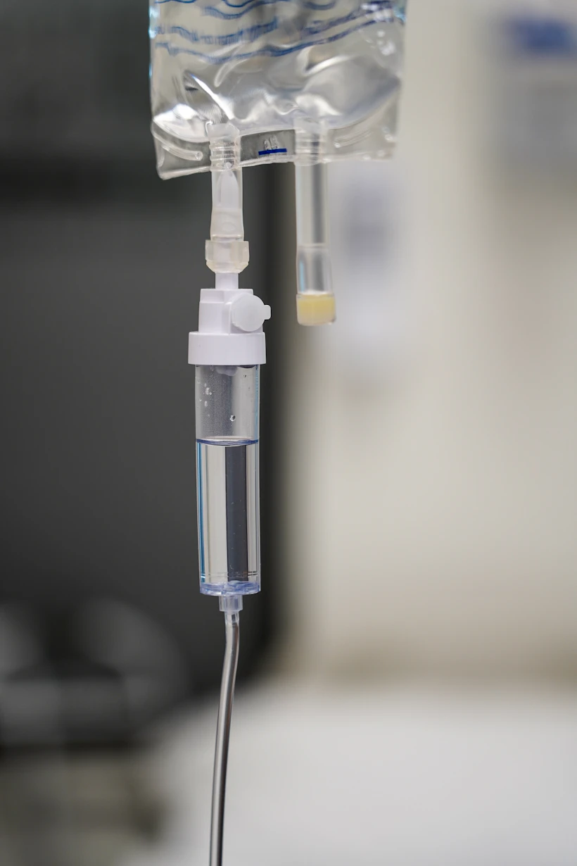 Home infusion nurse setting up IV therapy equipment for a patient in 2026