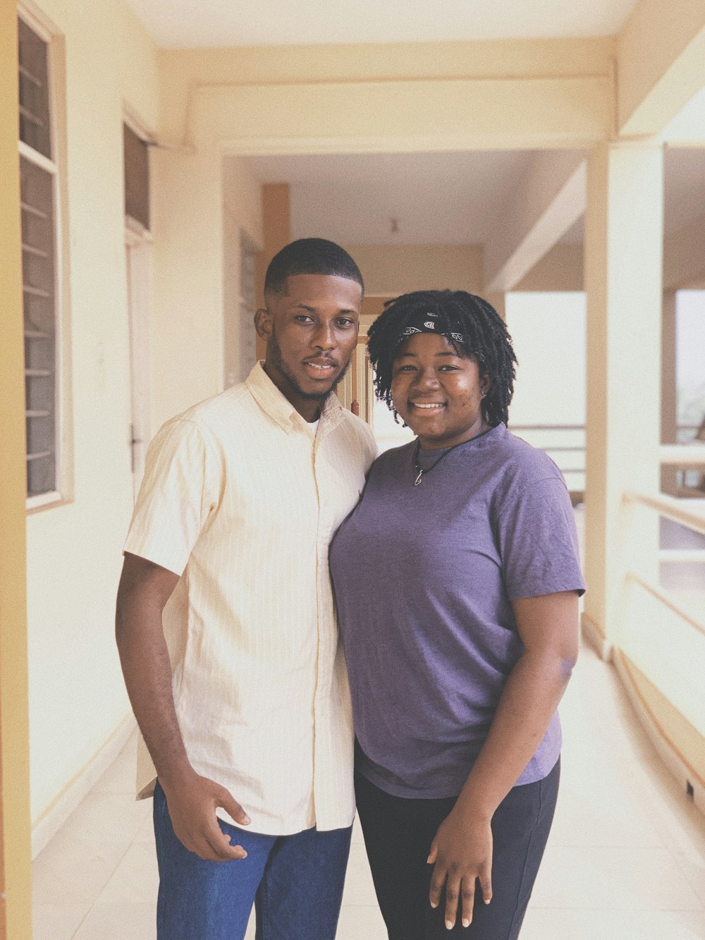 man in blue polo shirt standing beside woman in white button up shirt