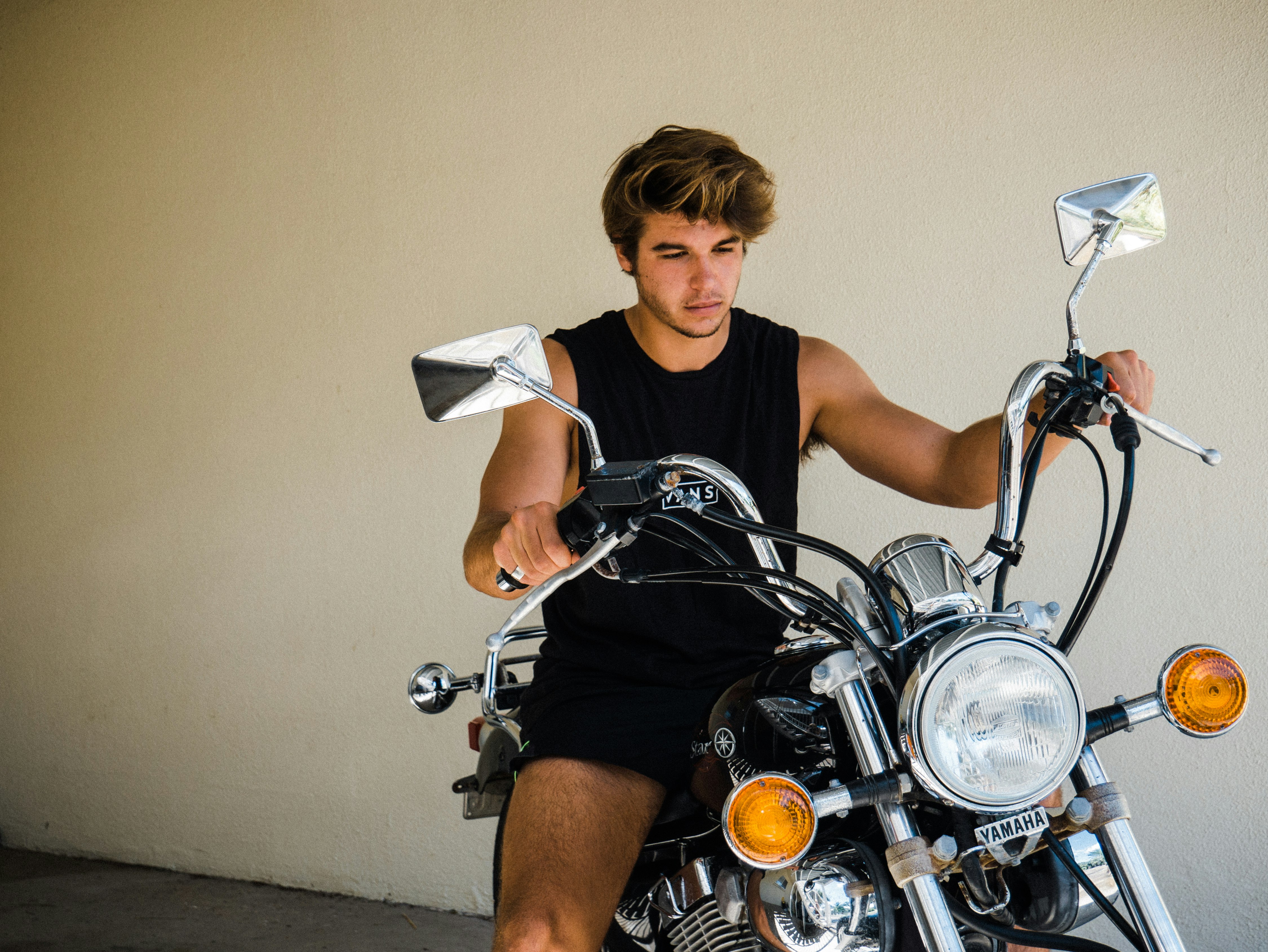 woman in white tank top riding on motorcycle