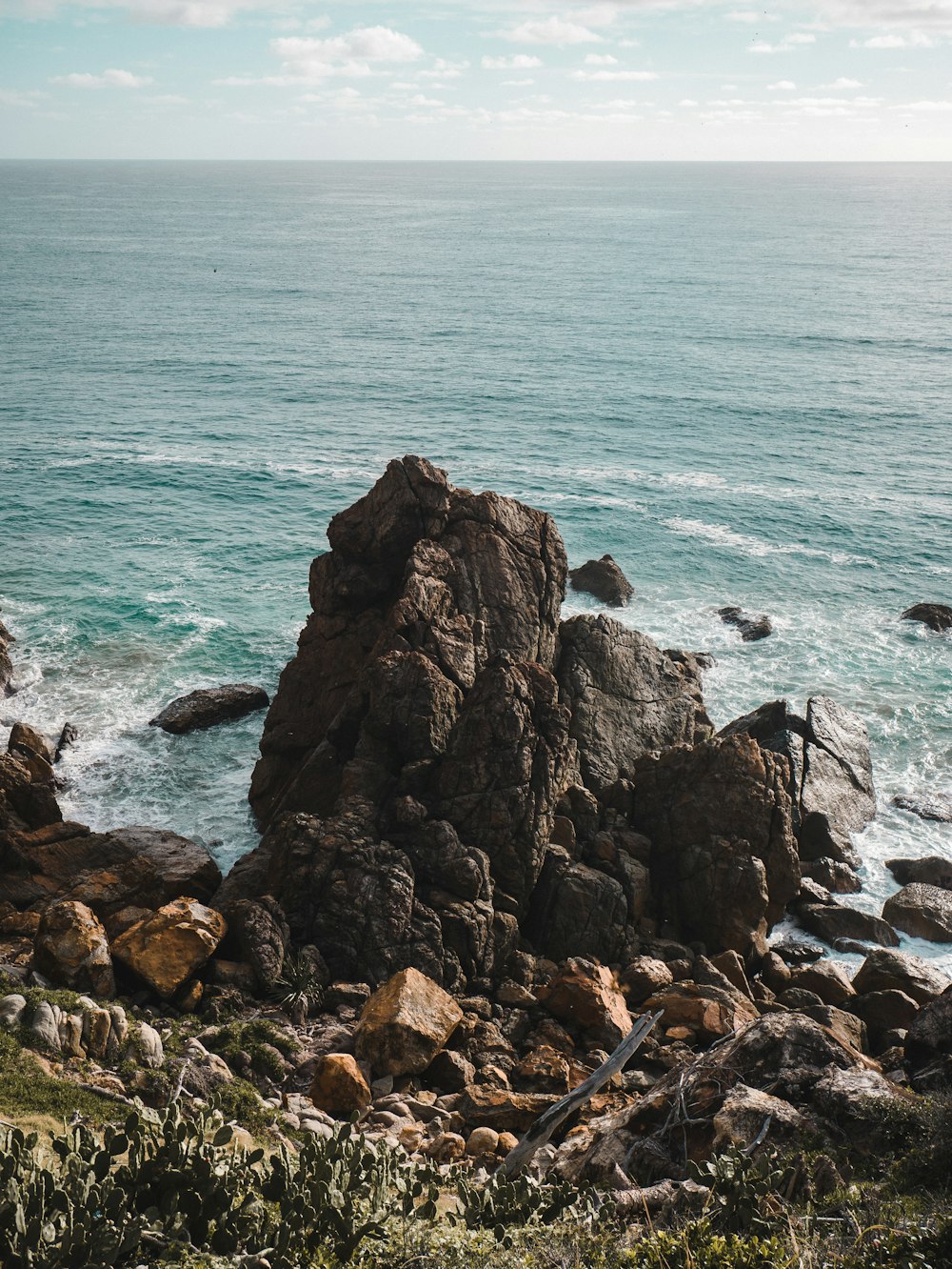 brown rock formation on sea during daytime