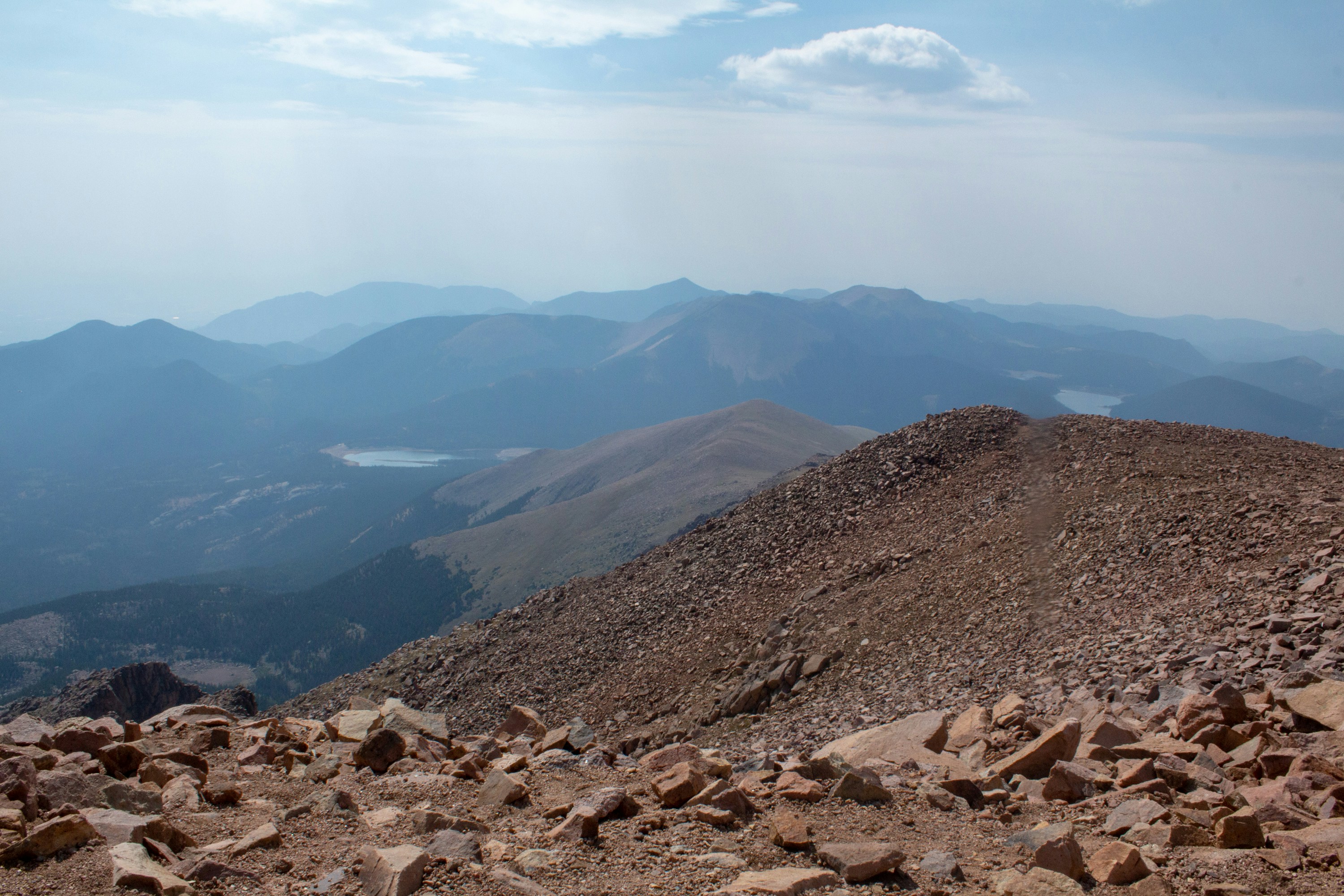 brown and gray mountains under white clouds during daytime