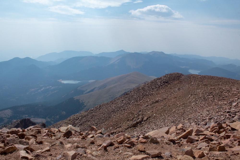 brown and gray mountains under white clouds during daytime