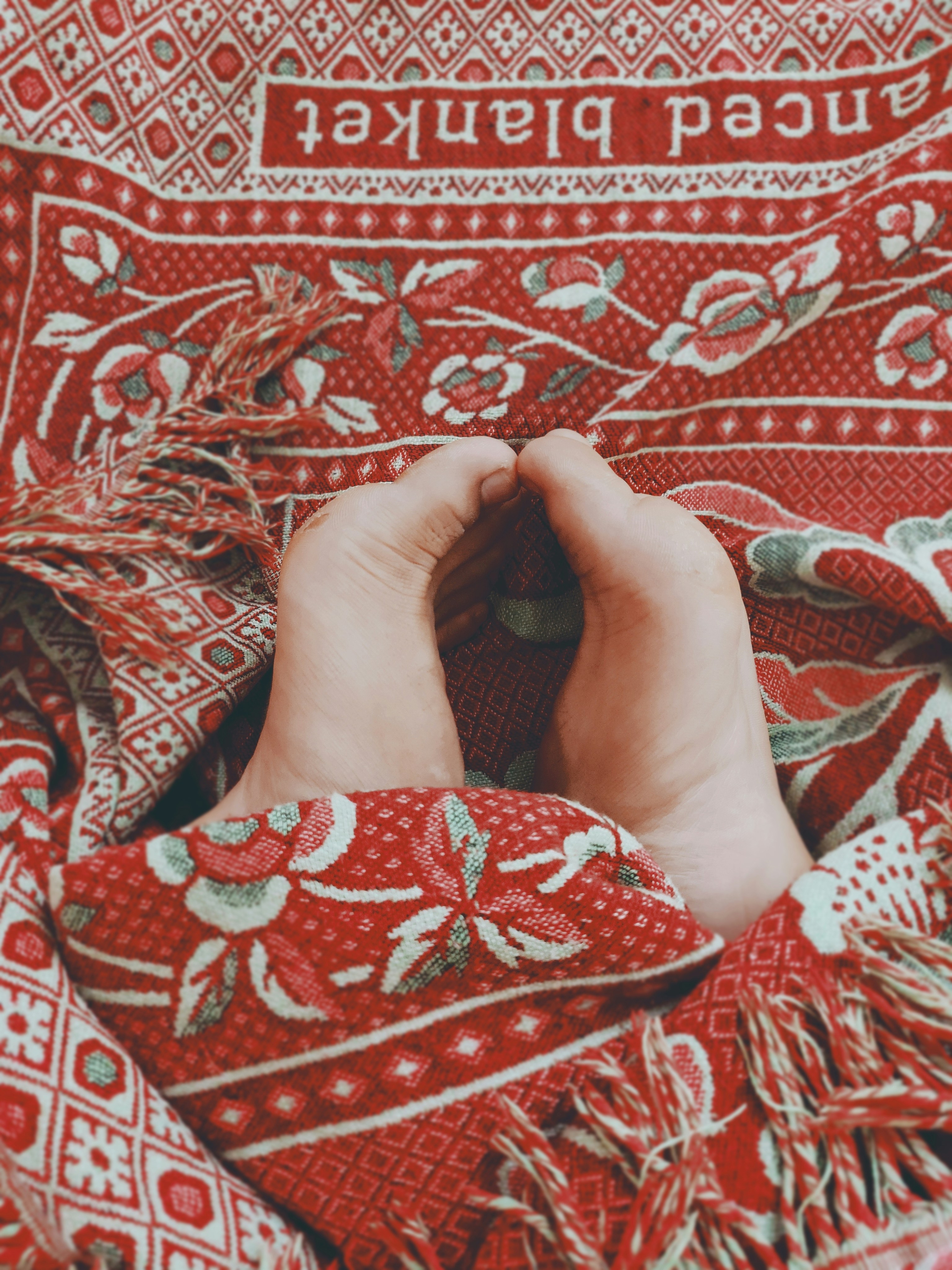 person wearing red and white floral pants