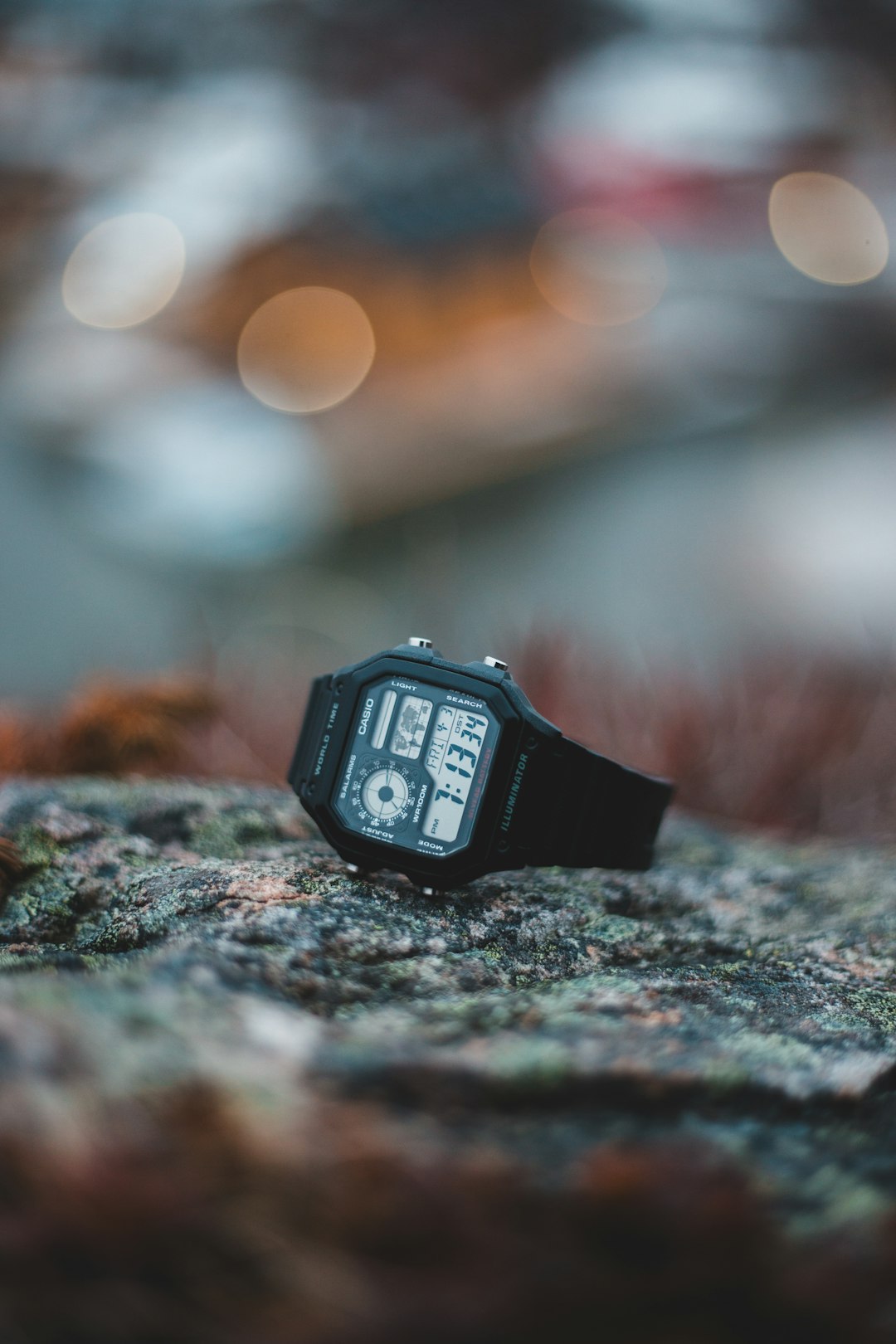 black digital watch on gray rock