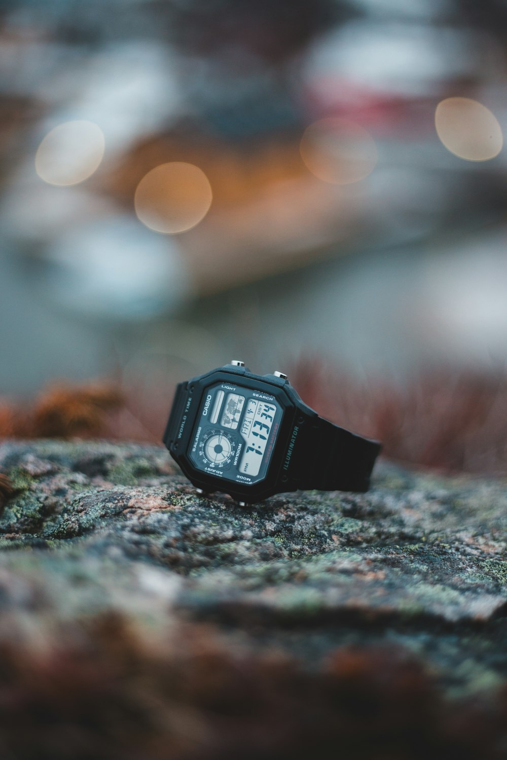 black digital watch on gray rock