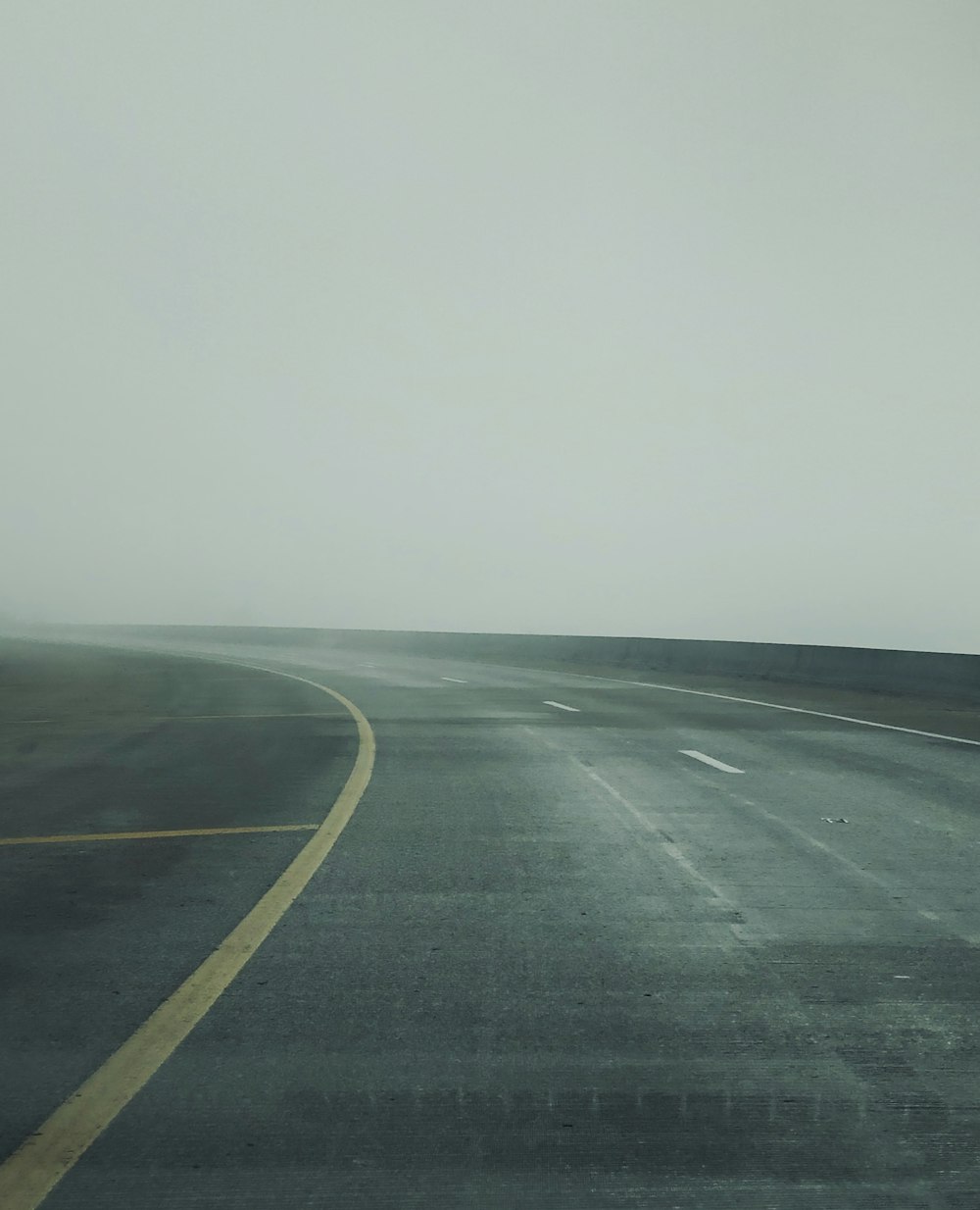 black asphalt road under white sky during daytime