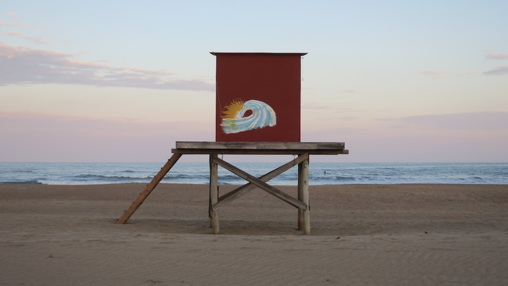 brown wooden lifeguard house on beach during daytime