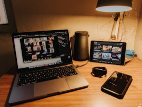 black and silver laptop computer on brown wooden table
