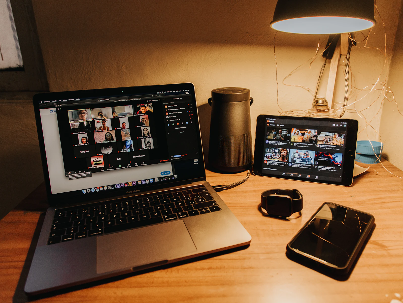 A laptop on a wooden desk ready for a call