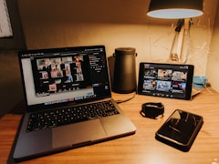 black and silver laptop computer on brown wooden table