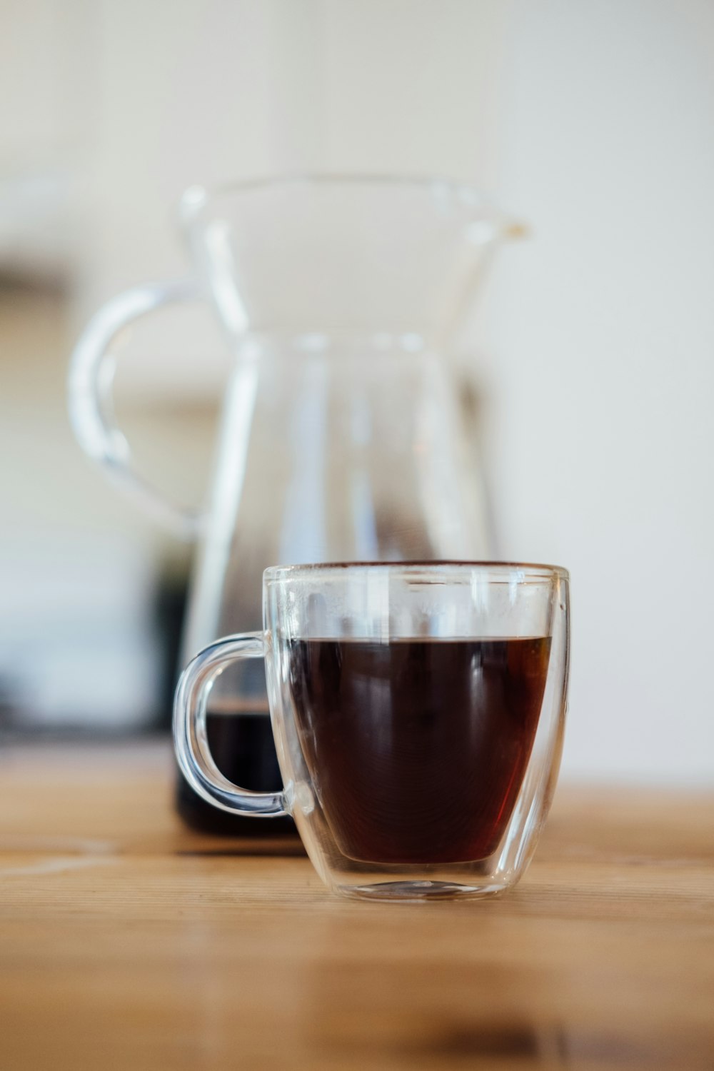 clear glass mug with brown liquid