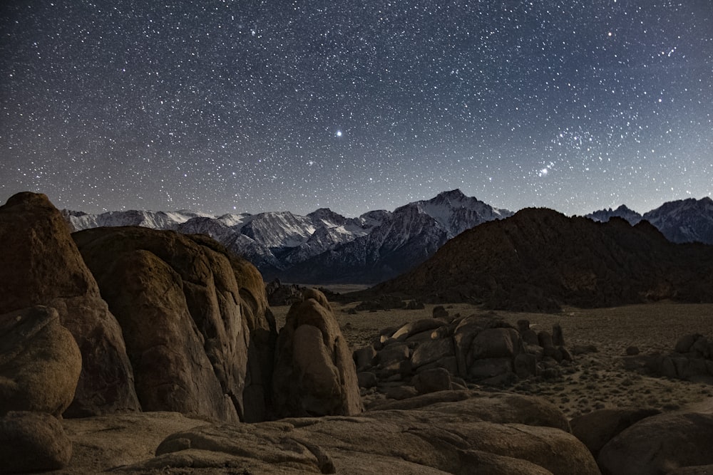 brown rocky mountain under blue sky during night time