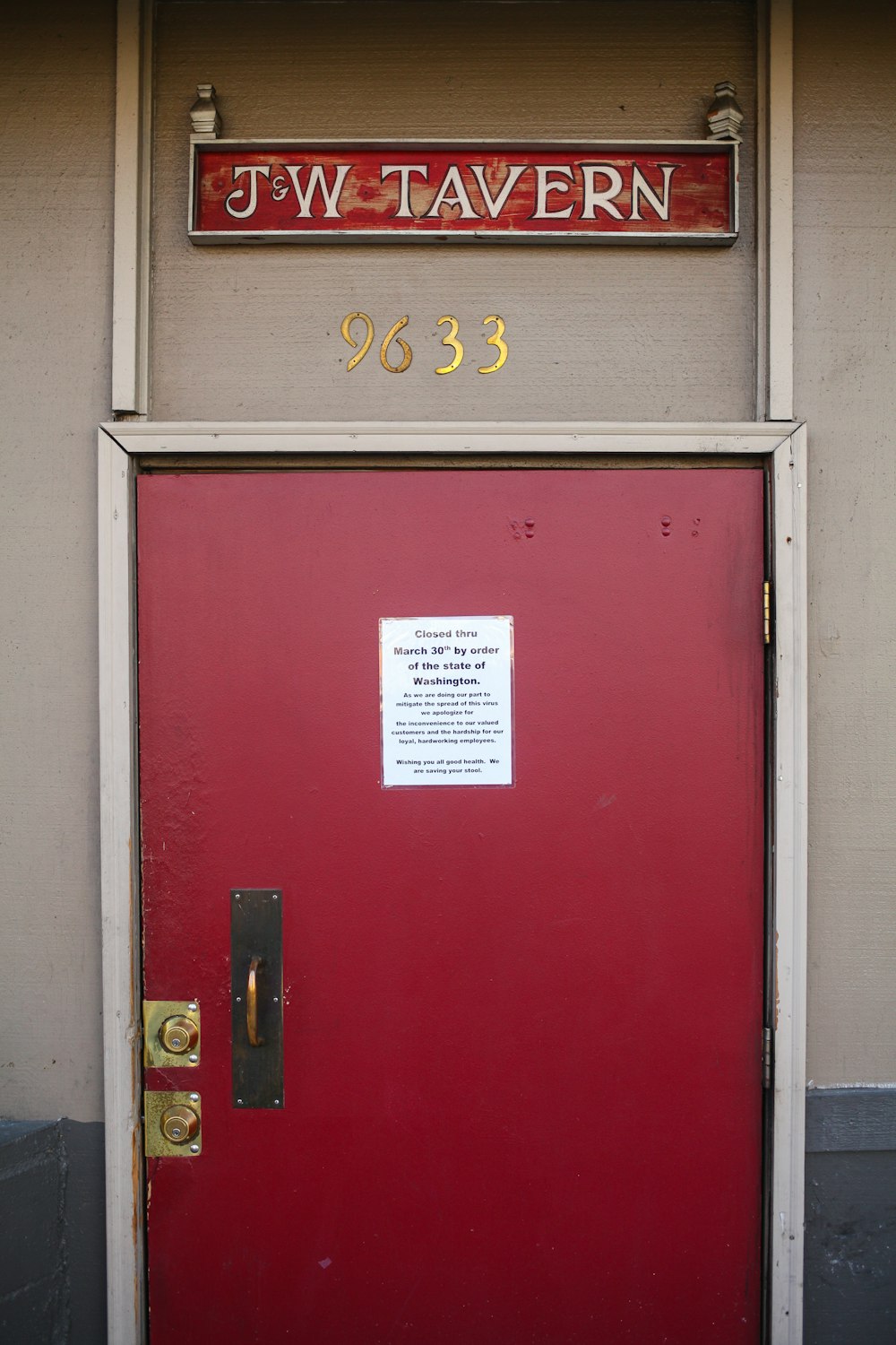 red wooden door with gold door lever