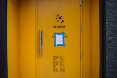 yellow metal door with blue and white sticker covid teams background